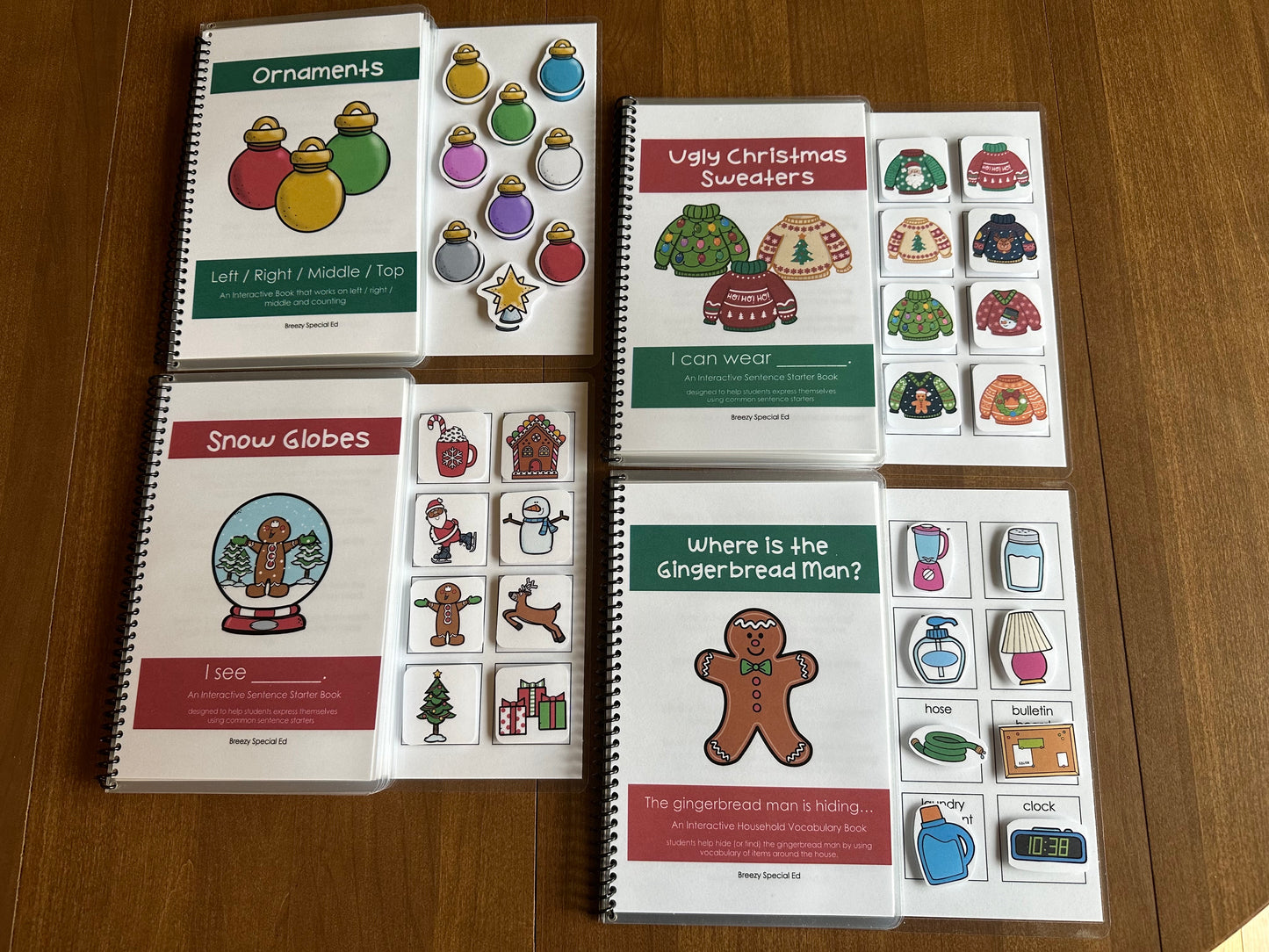 A set of three spiral-bound Christmas  themed interactive adapted books for special education, with various Christmas-related illustrations and activities designed for academic skills practice.