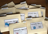 A set of community sign file folders with various signs illustrated on them, designed for educational use in special education.