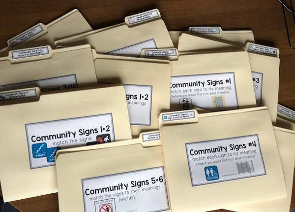 A set of community sign file folders with various signs illustrated on them, designed for educational use in special education.