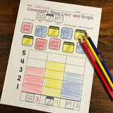 Special Education worksheet titled 'Community Signs Color and Graph' with colored pencils on a wooden surface.