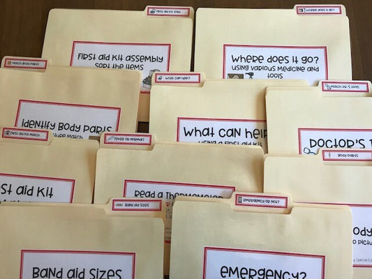 Laminated file folders with various labels attached with Velcro dots, designed for speical education purposes related to first aid and health skills.