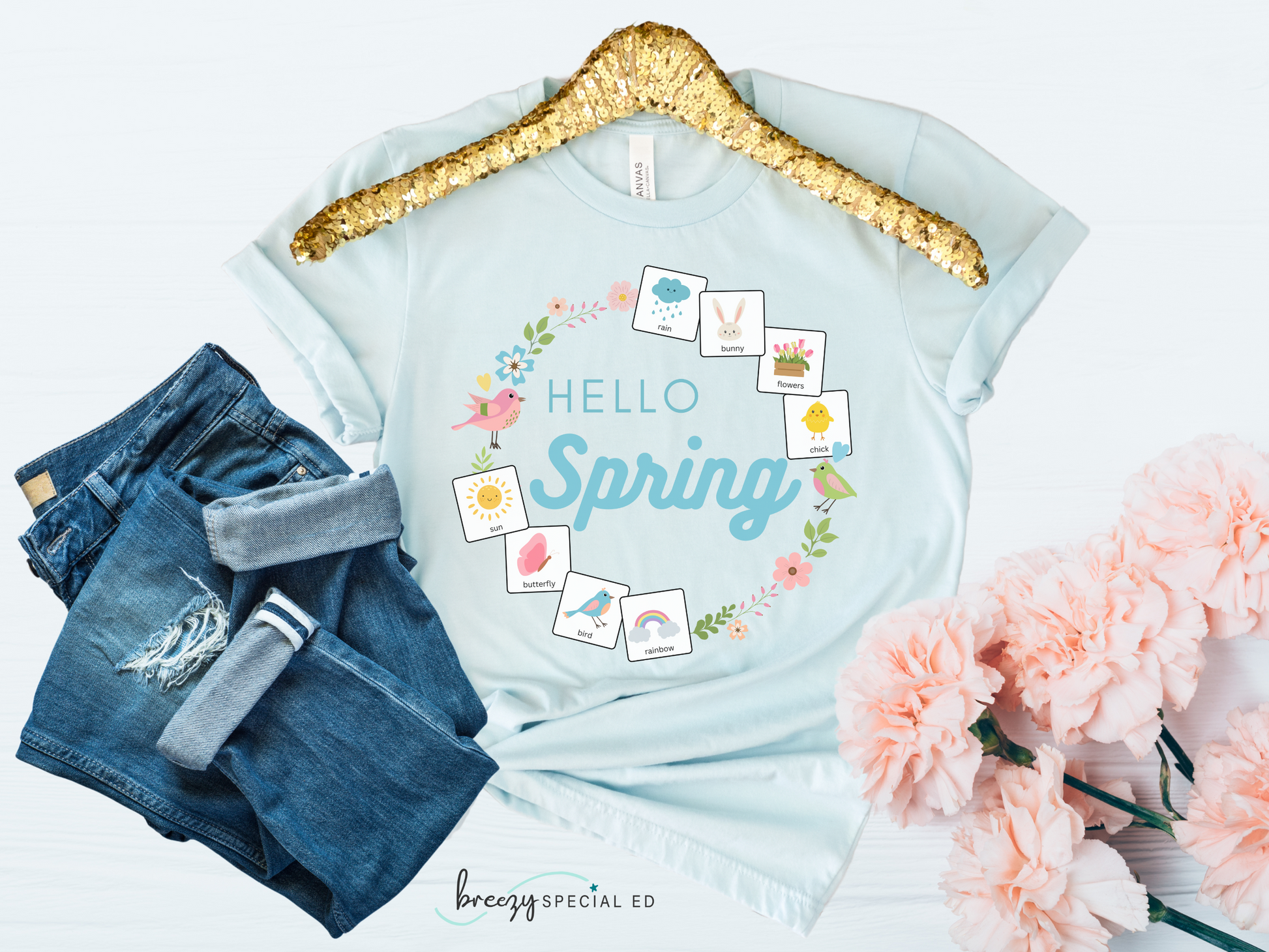 Light blue tshirt that says "hello spring" and includes a flower border and 8 symbol cards commonly used with AAC and special education