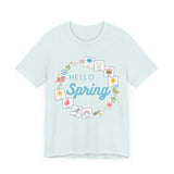 Light blue tshirt that says "hello spring" and includes a flower border and 8 symbol cards commonly used with AAC and special education