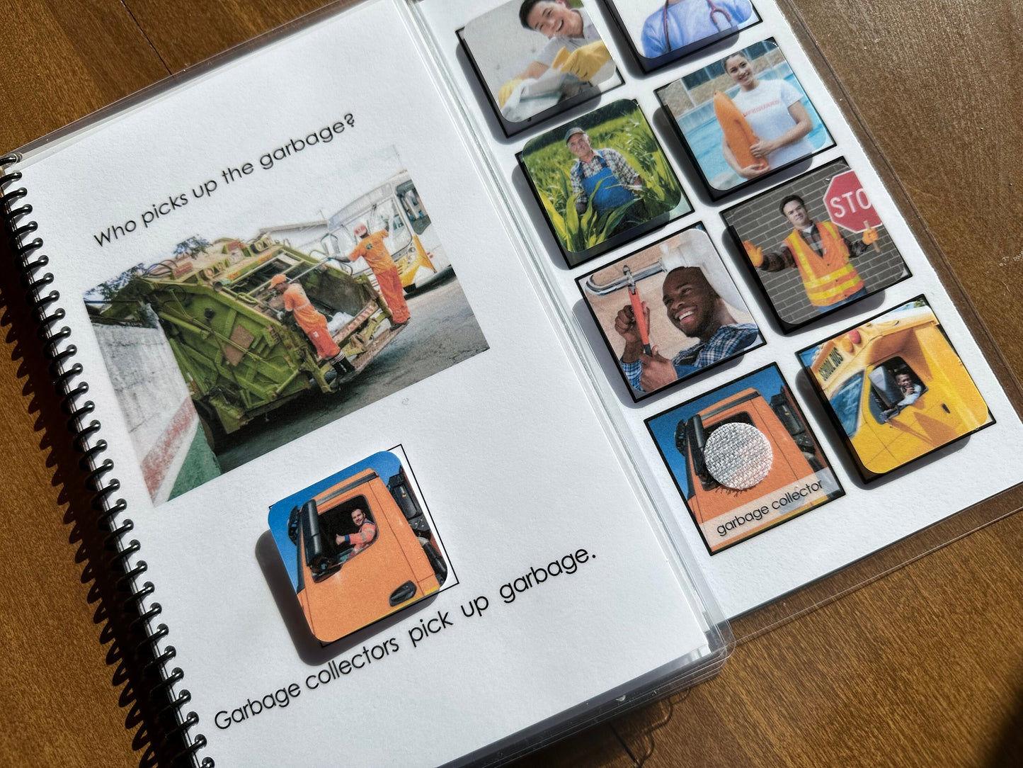 Spiral-bound adapted book book with images and text about garbage collectors on a wooden surface