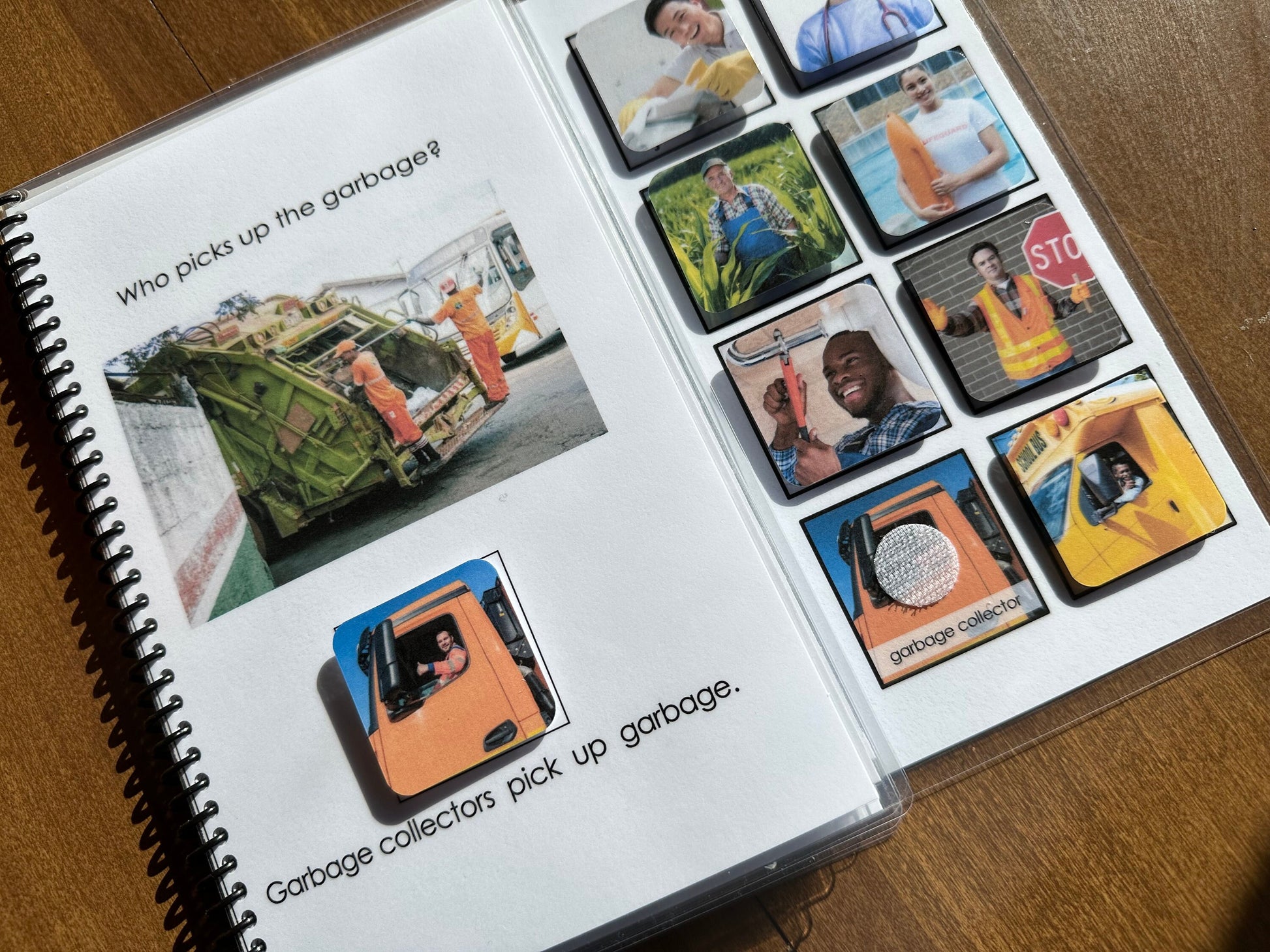 Spiral-bound adapted book book with images and text about garbage collectors on a wooden surface