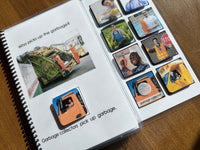 Spiral-bound adapted book book with images and text about garbage collectors on a wooden surface
