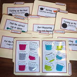 Set of kitchen and cooking themed file folders laid out on a surface, with colorful illustrations and labeled tabs for sorting measuring cups and spoons, stove temperatures, and other cooking-related activities.
