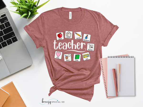 Mauve pink bella canvas tee shirt with the word TEACHER in the middle and AAC PECS symbols arounds the teacher text, symbols include: apple, school, pencil, backpack, teacher, bus, book, learn and love
