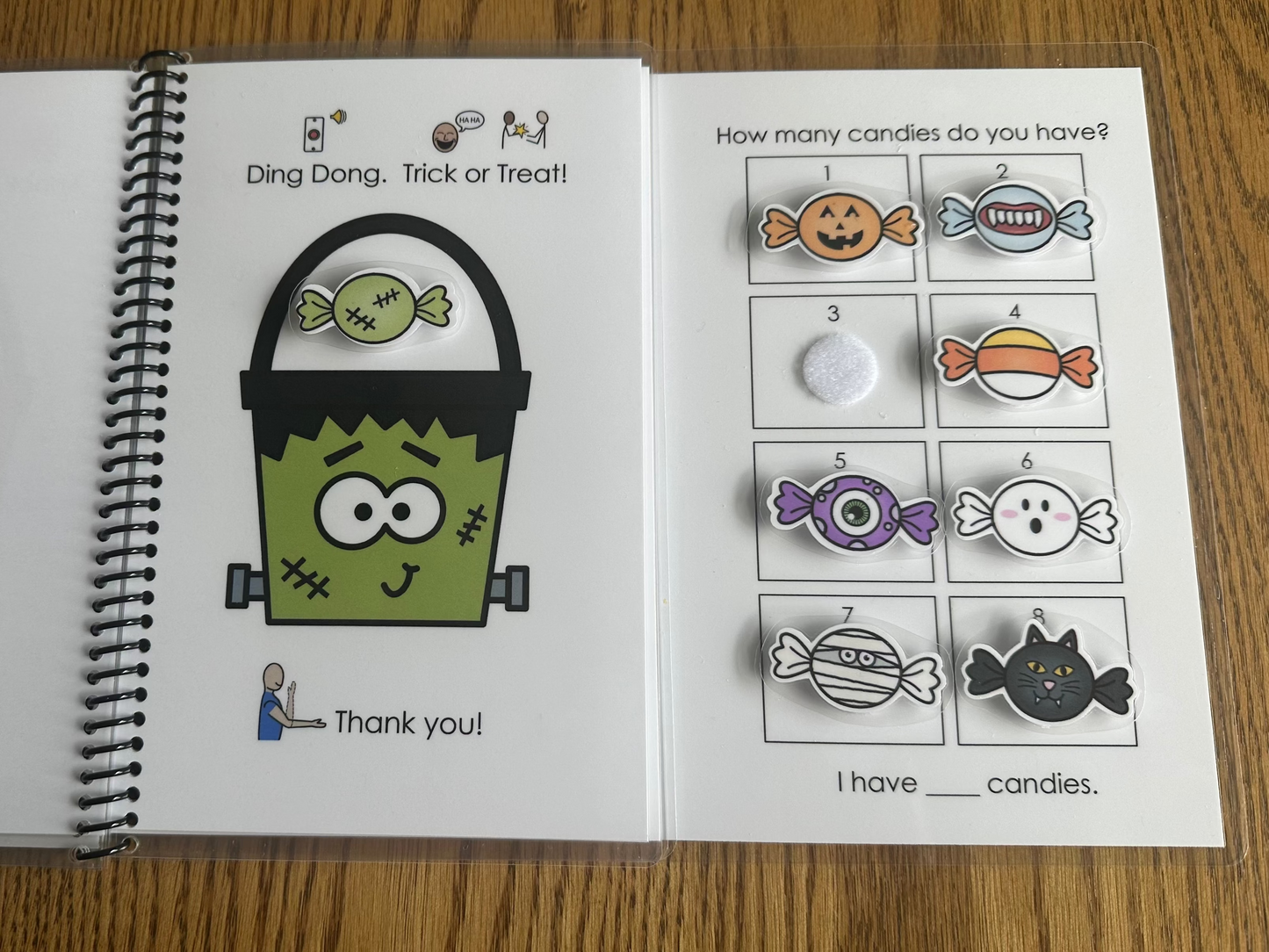 Adapted book with Halloween-themed symbols and pictures on a wooden surface