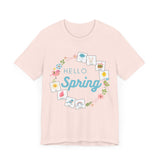 Light pink tshirt that says "hello spring" and includes a flower border and 8 symbol cards commonly used with AAC and special education