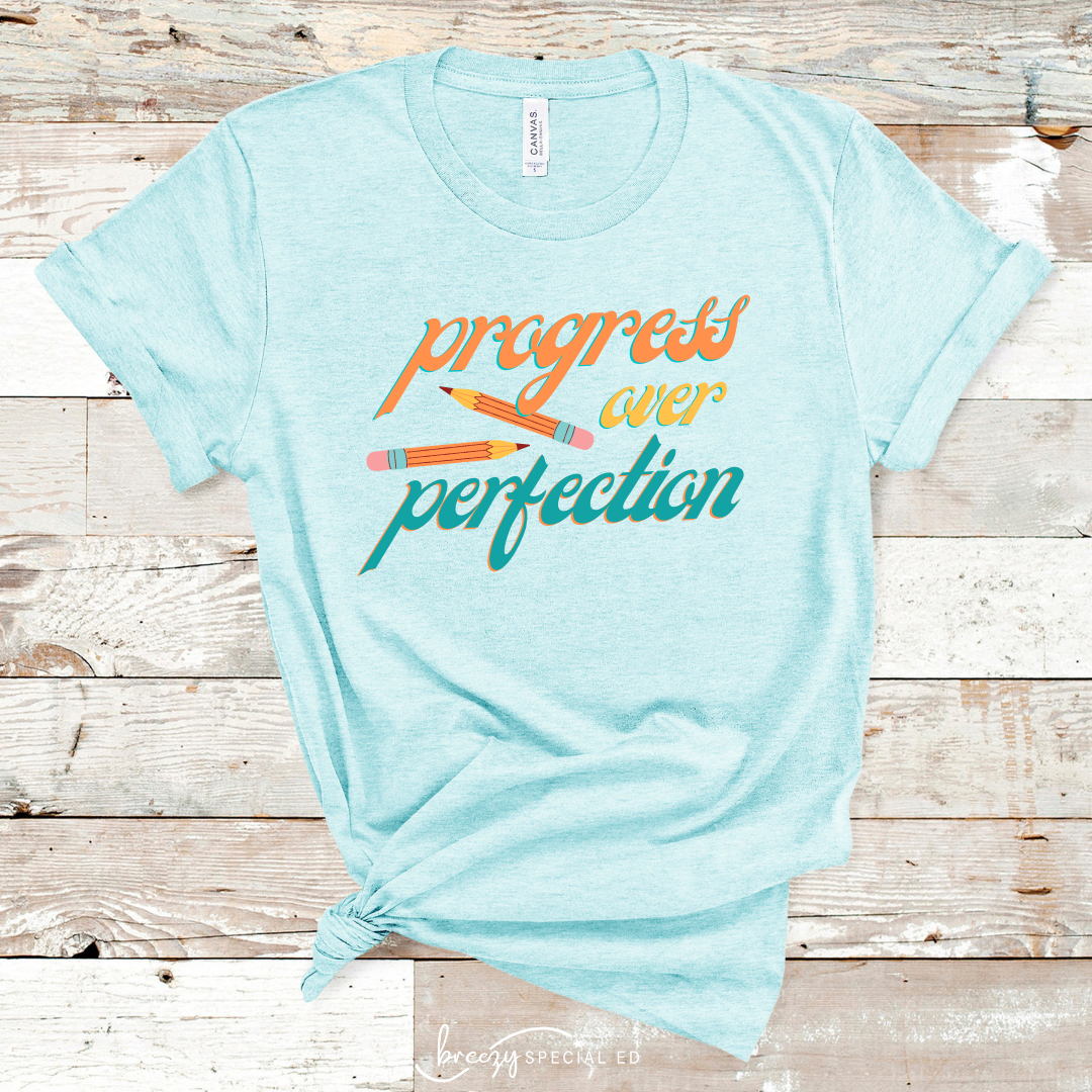 Heather Ice Blue bella+canvas shirt that says progress over perfetion