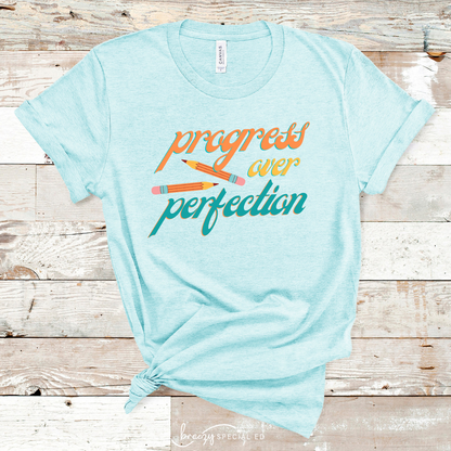 Heather Ice Blue bella+canvas shirt that says progress over perfetion