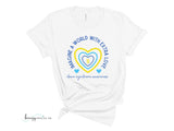 White Down Syndrome Awareness shirt with yellow and blue outlined hearts and arrows in the middle. Text around the heart says "Imagine a World with Extra Love"